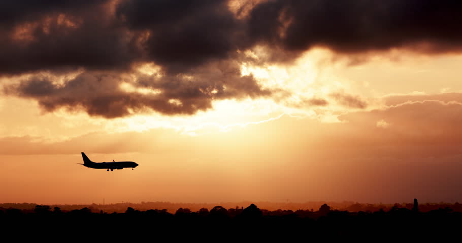 Jet airplane silhouette landing at the airport during sunset or dawn. Clouds and planes, tourism and commercial flight airlines. High-quality 4k footage | Shutterstock HD Video #1098276159