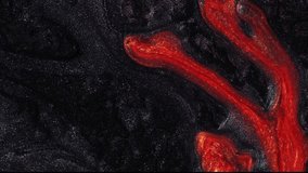 Dramatic artistic background video of movement lava . Footage with liquid shining orange flow. Abstract black texture with red-hot magma. Smartphone wallpaper or theme. Fluid art.