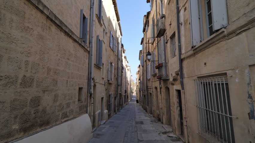 Typical narrow street in Montpellier France sunny day beige limestone buildings Royalty-Free Stock Footage #1098279771