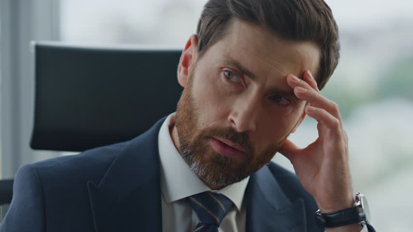 Serious executive director worried company financial results sitting in office close up. Portrait of stressed ceo owner man thinking about business problems in modern cabinet. Bearded businessman work | Shutterstock HD Video #1098288463