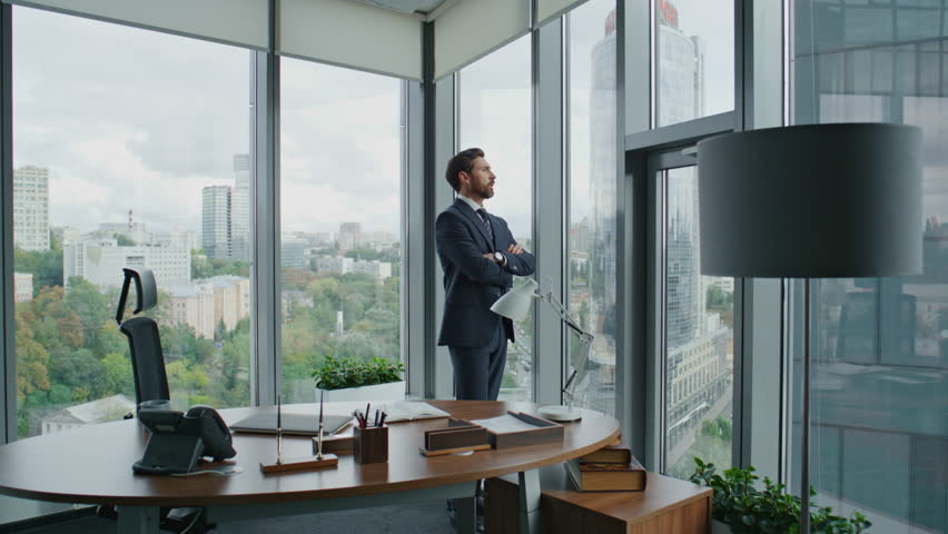 Confident professional investor standing modern office thinking about investing in business project. Thoughtful businessman worried company financial results. Owner ceo manager working in cabinet. | Shutterstock HD Video #1098288559