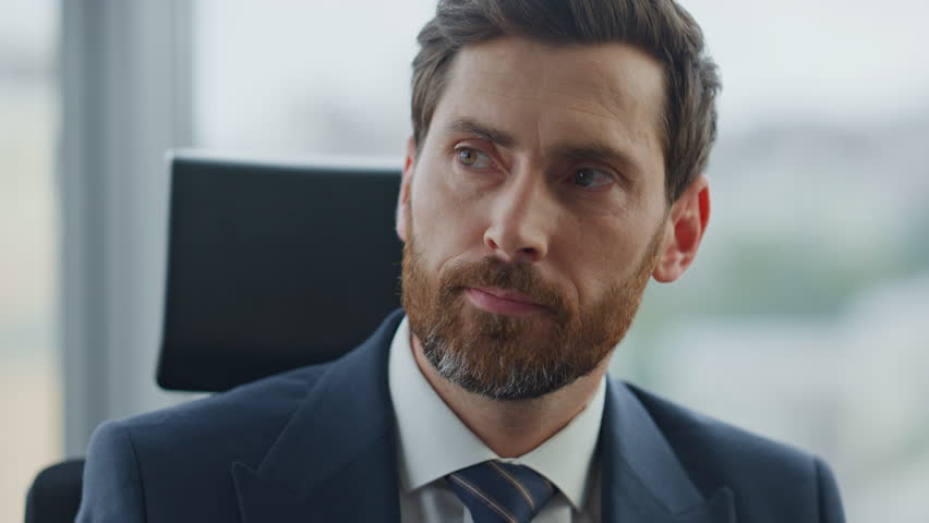 Confident successful boss drinking coffee sitting at company office close up. Portrait of bearded attractive businessman taking break in work tasting beverage. Serious man ceo thinking about career. | Shutterstock HD Video #1098288615