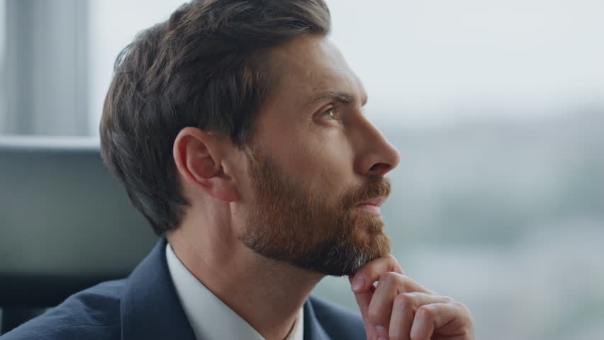 Bearded businessman thinking about business ideas sitting at modern office close up. Serious attractive company owner working at financial problems. Middle-aged ceo manager worried job opportunities. | Shutterstock HD Video #1098288651