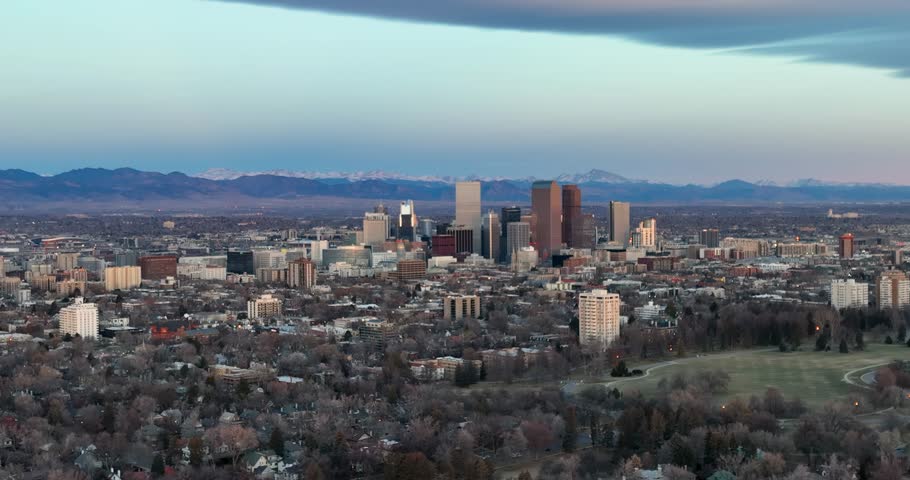 Aerial panorama of Denver downtown skyline in the winter season, snowy mountains in background