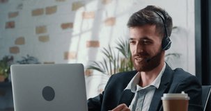 Close-up shooting, male mentor video chats with colleague and shares his professional experience to increase their career growth. Successful man with beard communicates online with work colleague