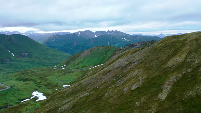 Aerial view of Hatcher Pass, Alaska. Mountain pass through the Talkeetna Mountains from above. Summer Alaskan landscape 