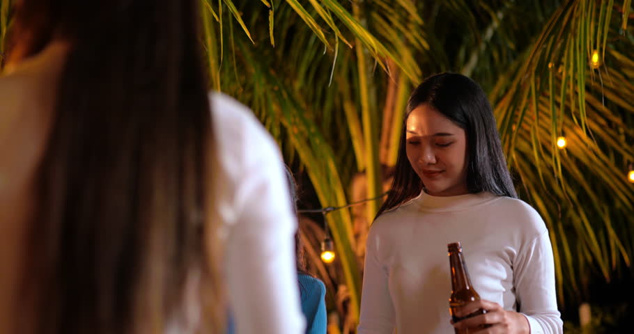 Footage of Happy Asian friends having dinner party together - Young people toasting beer glasses dinner outdoor  - People, food, drink lifestyle, new year celebration concept. | Shutterstock HD Video #1098299647