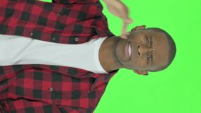 Vertical Video of Young African Man Looking Around and Searching on Green Background