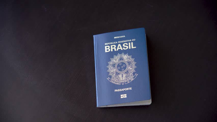 Man placing a Brazilian passport on the table. | Shutterstock HD Video #1098306875