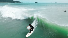 Surfer rides big wave in Vietnam during sunset. Handsome senior sportsman with beard,happy with riding on sea waves,lying on surfboard.Retired athlete surfs sea,surfing ocean lifestyle, extreme sports - Powered by Shutterstock - Get 15% off with code: PIKWIZARD15