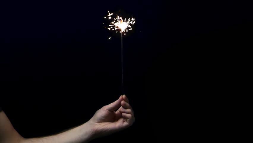 Sparkler in hand on a black background. | Shutterstock HD Video #1098313329