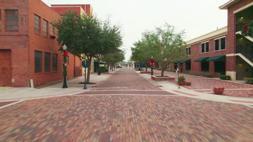 Low Aerial view of the charming brick roads of Downtown Winter Garden. Winter Garden is a family oriented biking town where residents ride in golf carts to shopping, restaurants, and bars.