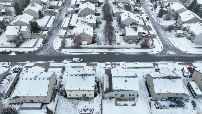 Overhead drone shot of houses in Spokane, Washington covered in snow.