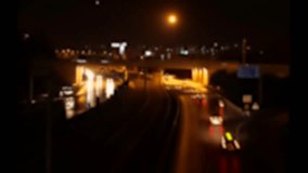 Night Road. Lots of cars driving along the interchange in the city. Timelapse. Nighttime traffic on the outskirts of a major city. Blurred video