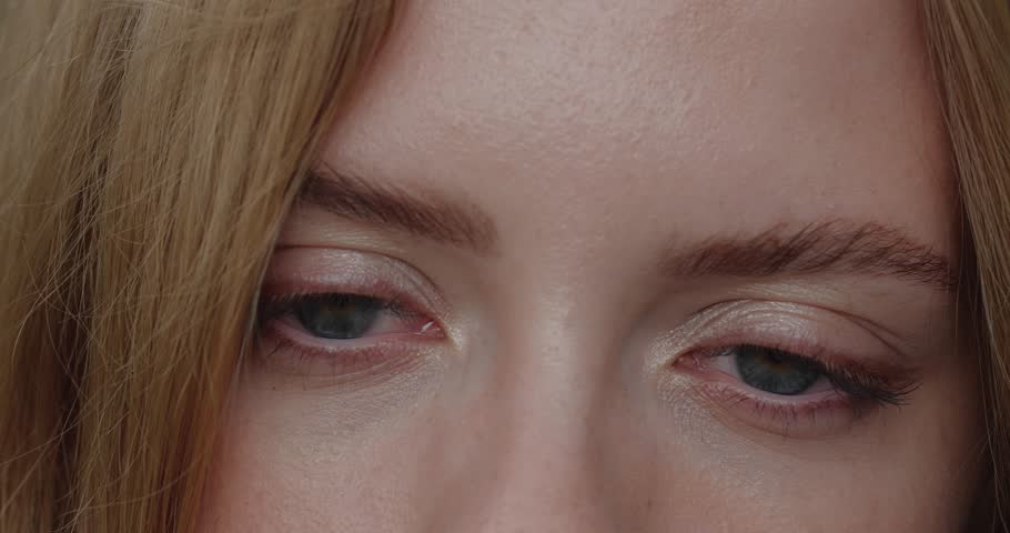 Extreme close-up of big blue eyes of an attractive blonde girl looking to side. Concept of ophthalmology and eye fatigue | Shutterstock HD Video #1098322465
