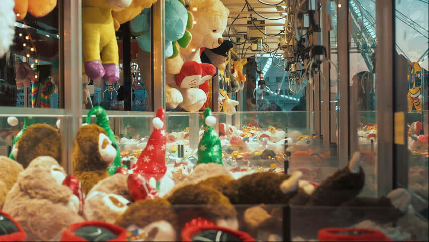 Entertainment for children in the amusement park. Claw Machines Toy Arcade game with stuffed animal toys on carnival.  Royalty-Free Stock Footage #1098325915