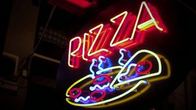 Pizza vintage neon sign light at night. Glowing illuminated advertisement 