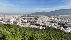 Aerial drone video of iconic tower of Athens the tallest structure in Metropolitan dense populated area in Kifisias and Alexandras avenues as seen from Lycabettus hill, Attica, Greece