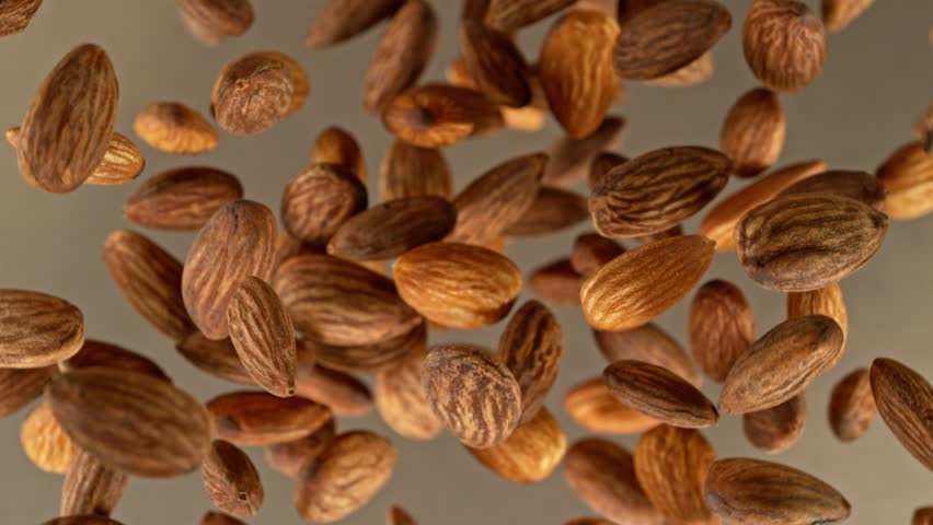 Super slow motion of rotating almonds up to the air. Filmed on high speed cinema camera, 1000fps, placed on high speed cine bot. Speed ramp effect. | Shutterstock HD Video #1098328005