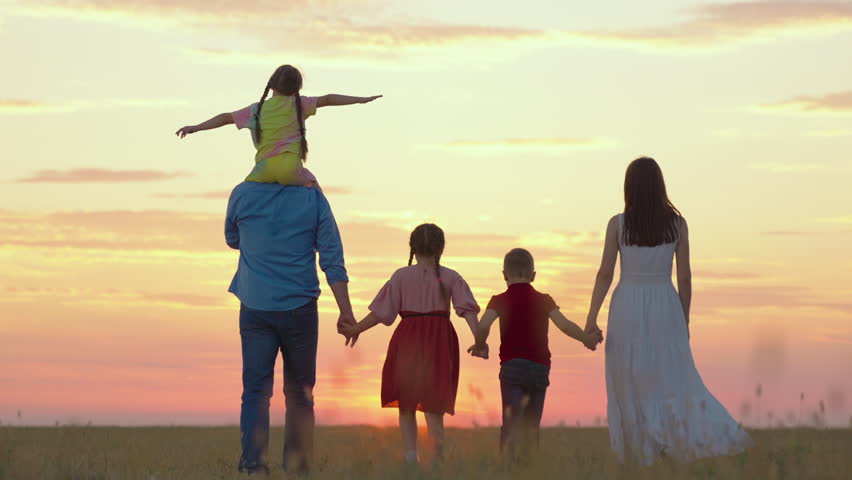 Big family, group of people outdoors in park. Spring, active family with children walks on grassy field. Daughter on shoulders of dad, mom, son, walk hand in hand outdoors. Parental care for children Royalty-Free Stock Footage #1098328877