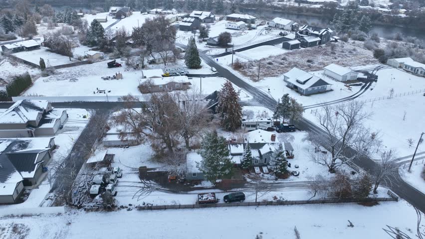 Rising aerial view of wealthy winter houses in Spokane, Washington near the Spokane River.