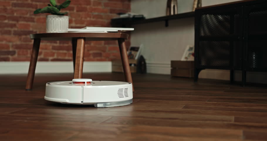 Isolated vacuum robot cleaner cleaning the floor at home, still shot with copy space of modern housework | Shutterstock HD Video #1098331815