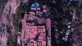 Vertical video of Aerial shot of sacred Hindu temple complex on hill in Palani from above