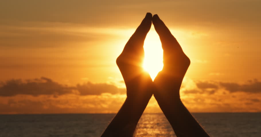 Woman hand close up at golden sunset, sun flare human hand inside, peace and meditation simbol, love, relax and healthy life concept, Silhouette of girl hand at sunset, sea ocean beach scene