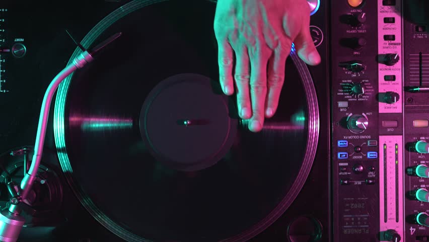 Dj scratches vinyl record on turntable. Hip hop disc jockey scratching disc with music in flat lay video clip filmed from above Royalty-Free Stock Footage #1098339985