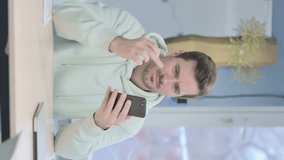 Vertical Video of Young Adult Man Reacting to Loss on Smartphone