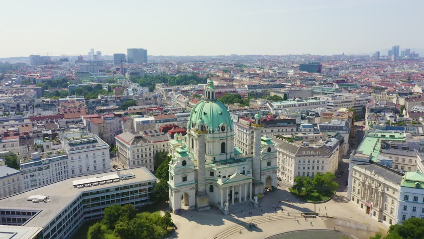 Inscription on video. Vienna, Austria. Karlskirche is a Catholic church located in the southern part of Karlsplatz in Vienna. Shimmers in colors purple, Aerial View