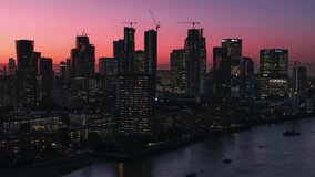 Establishing Aerial View Shot of London UK, United Kingdom, Canary Wharf, Business District, beautiful colours, red sunset