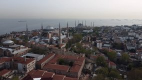 Drone shot of Hagia Sophia and the Blue Mosque in Istanbul - drone is approaching the mosques from far. Snippet could ideally be used for travel or Istanbul related movies and Europe or Turkey videos.