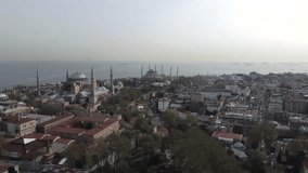 Drone shot of Hagia Sophia and Blue Mosque in Istanbul - drone is facing the mosques from far. Snippet could ideally be used for travel or Istanbul related movies and Europe or Turkey videos.