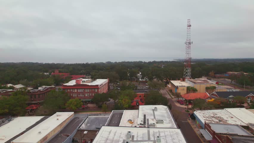 Aerial flyover of the charming and quaint city of Downtown Winter Garden, Florida. Winter Garden is a family oriented biking town where residents can ride in golf carts to the restaurants and bars.