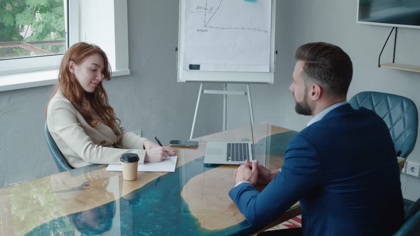 Female HR manager in a business suit is hiring male candidate for the position of department head. A man in suit is interviewing for a job with a woman HR manager in modern office. Job search concept | Shutterstock HD Video #1098358577