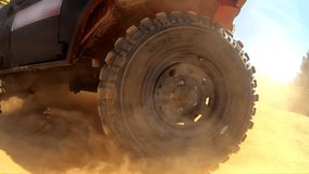 Closeup of wheels suv driving along desert road. Slow motion. Concept of competitions in fast driving on off-road SUVs, wanderlust - Powered by Shutterstock - Get 15% off with code: PIKWIZARD15