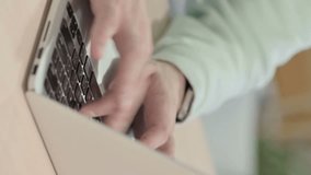 Vertical Video of Man Typing on Laptop