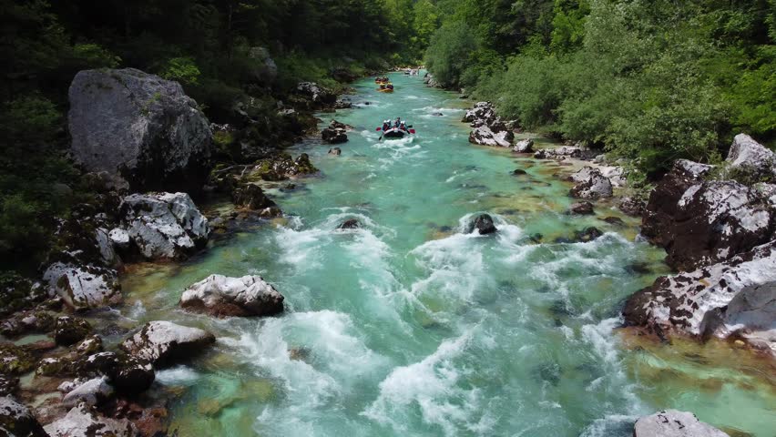 Soca Valley, Slovenia - 4K Aerial shot of white water rafting on River Soca. Whitewater rafting teams going down the emerald alpine river Soca on a bright summer day Royalty-Free Stock Footage #1098388249