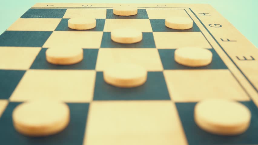 A wooden board of a draughts checkers strategy game, slow motion, close up shot, 4K