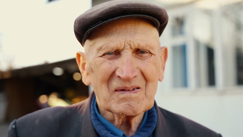 Grandfather who looks sadly into the camera. | Shutterstock HD Video #1098393369