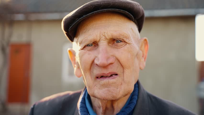 Portrait of a heavily sighing grandfather looking at the camera | Shutterstock HD Video #1098393373