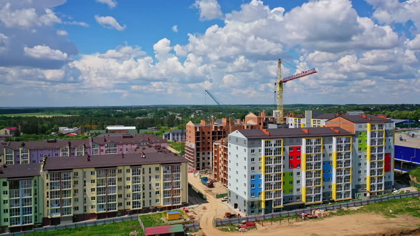 Building of a modern district. Construction site of new complex with high rise buildings. Colorful apartment building in new microdistrict. Royalty-Free Stock Footage #1098393467