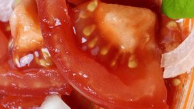 Eating fresh vitamin salad, fork take slice of tomato and onion on brown plate. Healthy vegetarian or vegan food. Mediterranean diets food. Selective focus. Vertical video.
