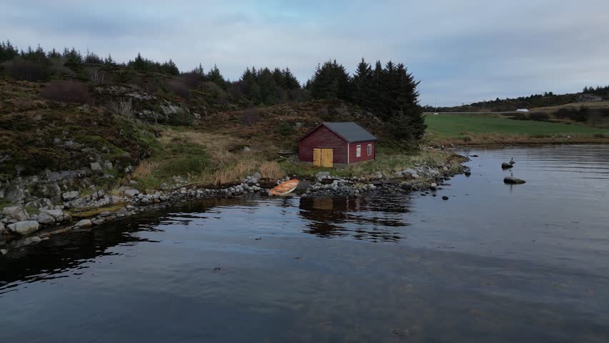 flying over the water of the marine north sea in the bay with rocks in norway small fisherman