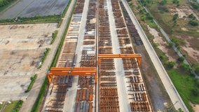 4K : Drones are flying over a many steel material on outside storage yard, exterior of a large metallurgical. steel industry. logistics and infrastructure concept. southeast asia. aerial view footage
