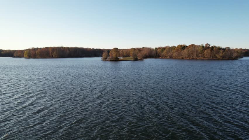 Aerial Drone Video of Lake in Virginia with Person Kayaking in the Distance before Sunset