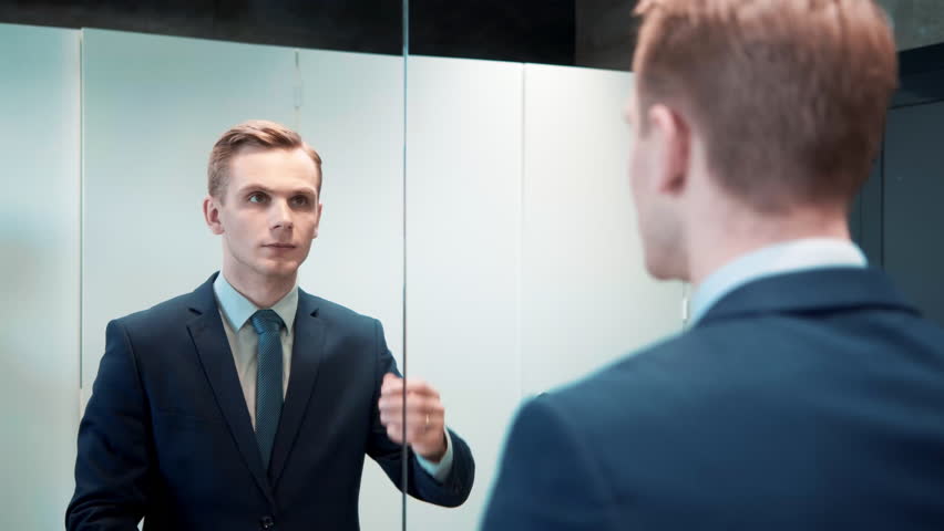 Business man in office bathroom. Stressed manager using restrooms, washroom and lavatories while looking at receding hairline. Male beauty in public toilet with businessman checking hair for loss Royalty-Free Stock Footage #1098409337