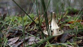 A clip of a brass incense burner burning resin in the meadow. Brass incense burners used for spiritual rituals.