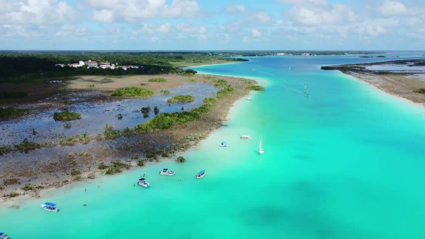 Aerial view of boats in lagoon 7 colors. Bacalar Mexico Royalty-Free Stock Footage #1098415875